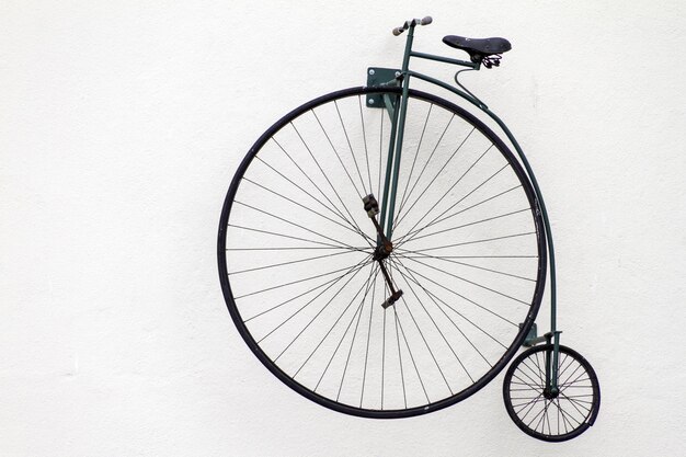 Closeup shot of an old bicycle with a big wheel on a white background