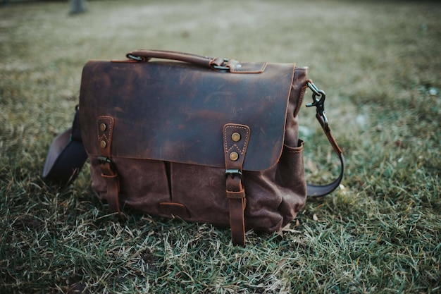 closeup shot of an old and classic sling bag left on the ground