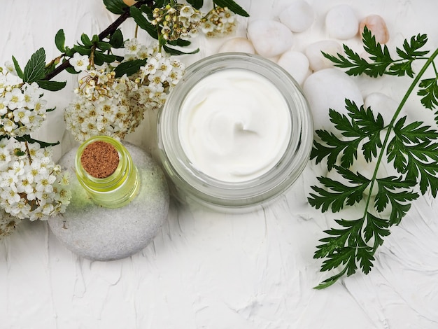 Closeup shot of organic oil and cream. green cosmetic arrangement, Fresh herbal skincare cosmetics.