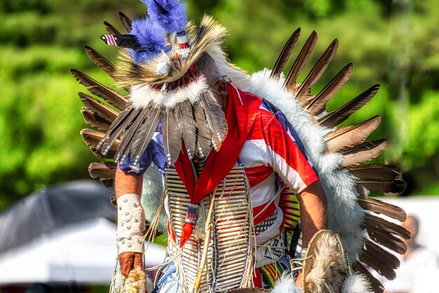 Closeup shot of a person in a colorful traditional Indian-American festive costume with feathers