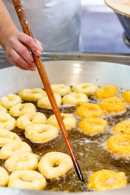 Closeup shot of the process of making doughnut or donuts