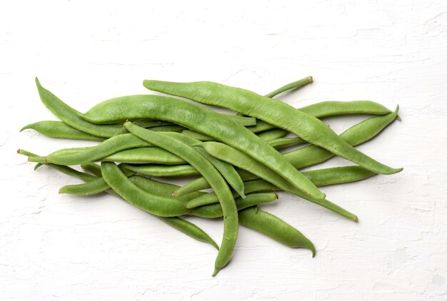 Closeup shot of raw green beans isolated on a white background