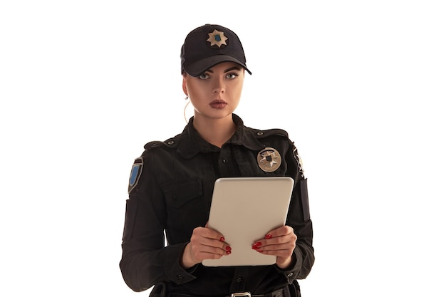 Closeup shot of a redheaded female police officer posing for the camera isolated on white background