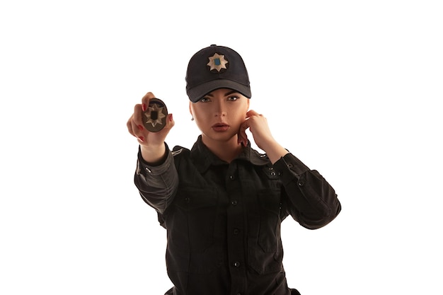 Closeup shot of a redheaded female police officer posing for the camera isolated on white background