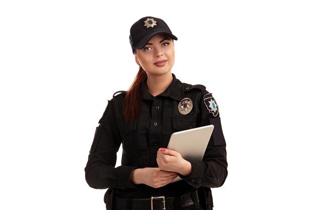 Closeup shot of a redheaded female police officer posing for the camera isolated on white background