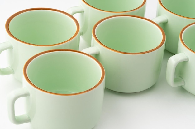 A closeup shot of a set of ceramic kitchen utensils on a white background