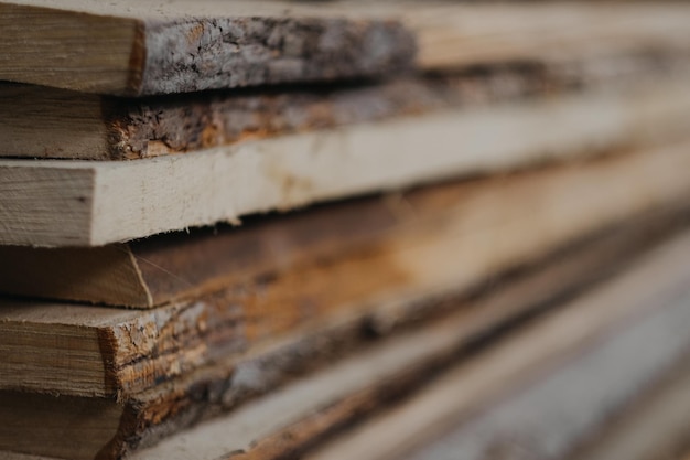 Closeup shot of a stack of rough wooden planks