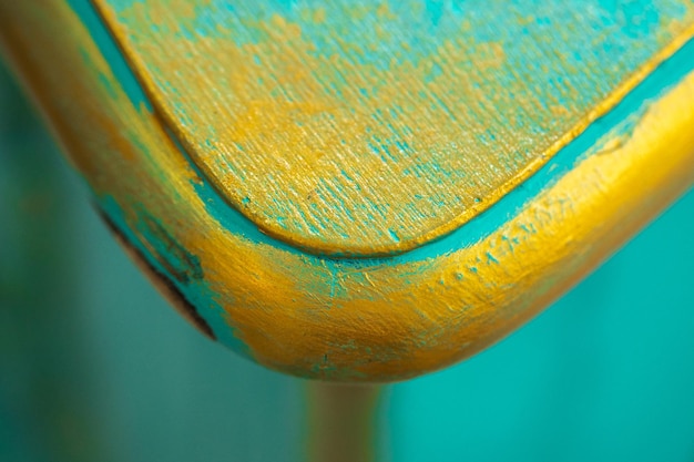 Closeup shot of textured wood with yellow and blue grunge paint, isolated wallpaper