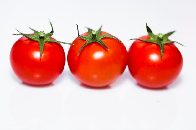 Closeup shot of tomatoes on a white background