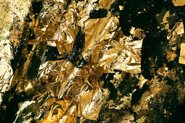 Closeup shot of uneven surface covered with gold foil