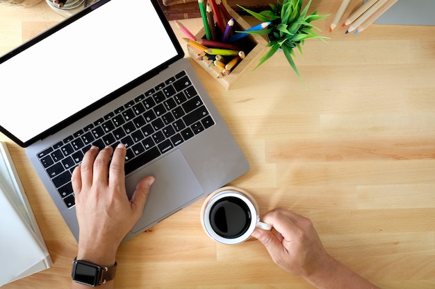 Closeup shot of an unrecognizable businessman using a laptop in an office