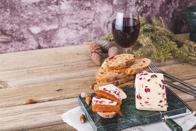 A closeup shot of Wensleydale cheese with cranberries and wine