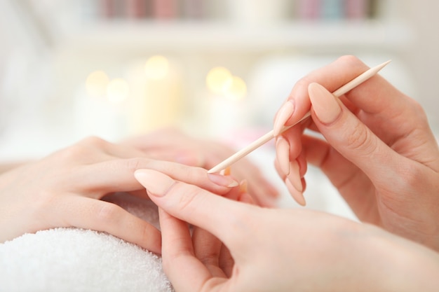 Closeup shot of a woman in a nail salon getting a manicure