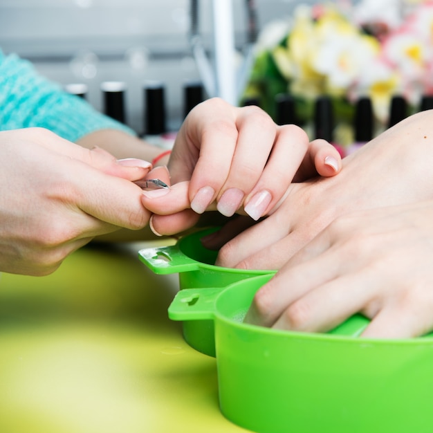 Closeup shot of a woman in a nail salon receiving a manicure