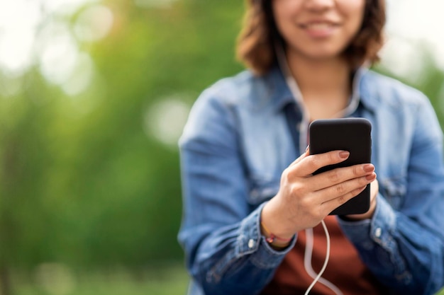 Closeup Shot Of Young Arab Woman Using Smartphone Outdoors