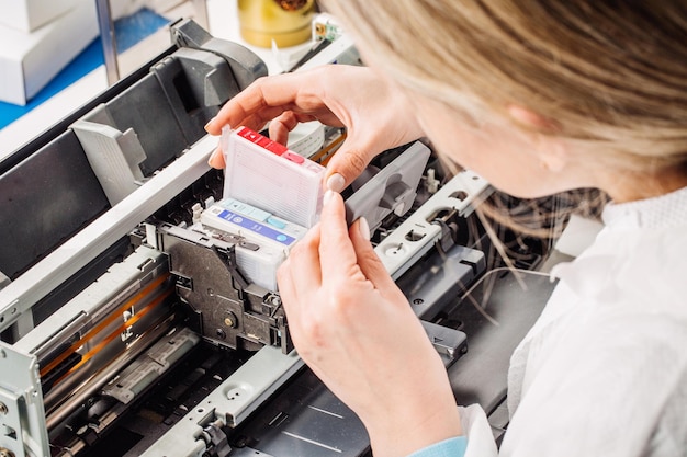 closeup shot young female technician repairing digital printer