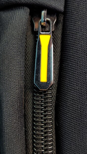 A closeup shot of the zipper on the luxury black bag