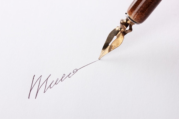 Closeup of signature fake not real and ink pen isolated on white