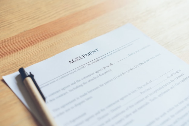 Closeup of signing a documentation agreement and pen on the table.