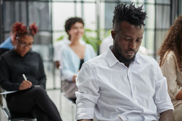 A closeup of sitting in a board room making notes