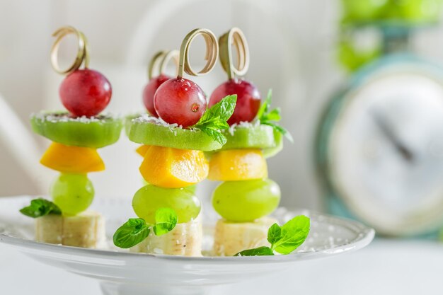 Closeup of skewers with fruits and mint