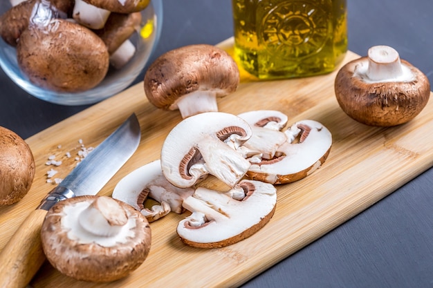 Closeup of a slice of edible mushroom Royal champignons on a cutting board Delicious and healthy food concept