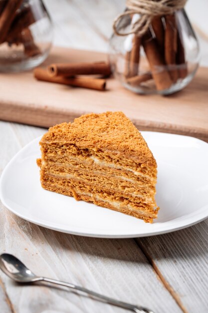 Closeup on slice of honey cake on the wooden table