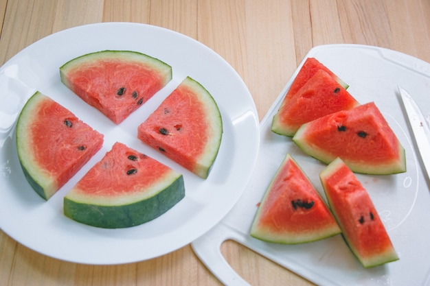 Closeup slice pieces of refreshing watermelon on a wooden space