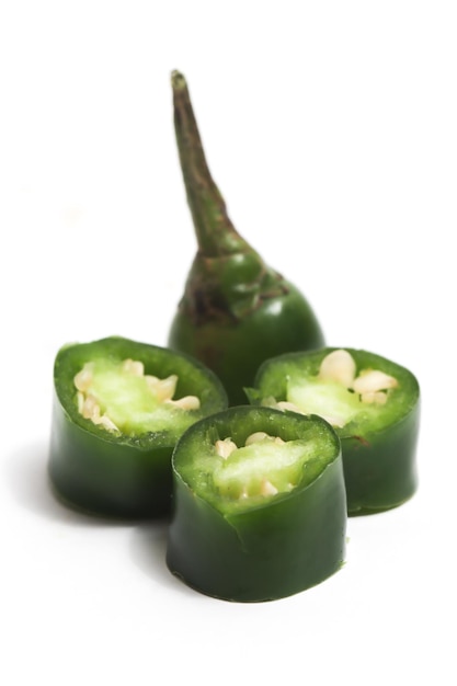 Closeup sliced green hot chili pepper isolated on white background clipping path