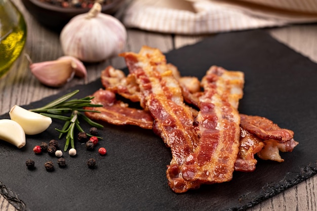 Closeup of slices of crispy hot fried bacon