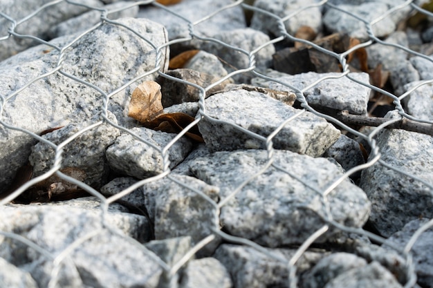 Closeup slope of natural stone covered with a metal mesh. 