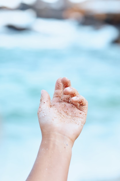 Closeup Small Grain of Sand in Open Woman Hand