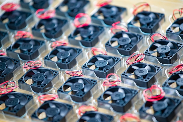 Closeup small plastic computer coolers with wires on a wooden table