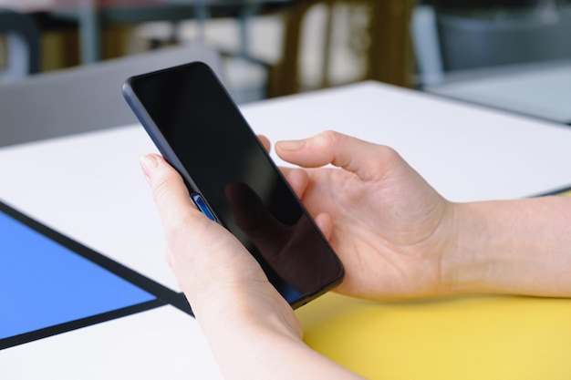 Closeup of a smartphone in female hands Woman Using smartphone