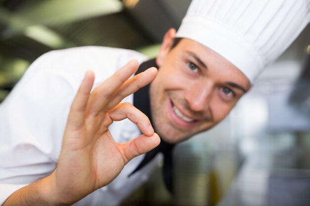 Closeup of a smiling male cook gesturing okay sign