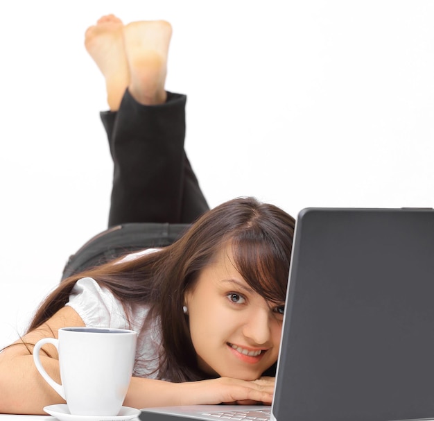 Closeup smiling young woman with laptop in the workplace