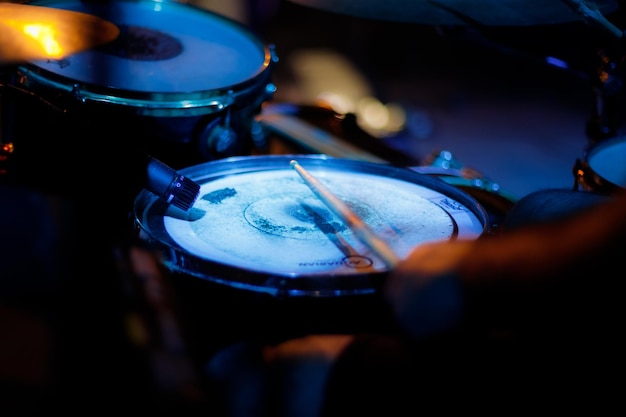 Closeup of a snare drum being played by a drummer in concert