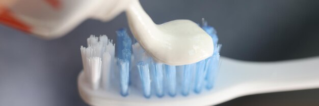 Closeup of snow white toothpaste on tooth brush morning hygiene teeth cleaning and stomatology