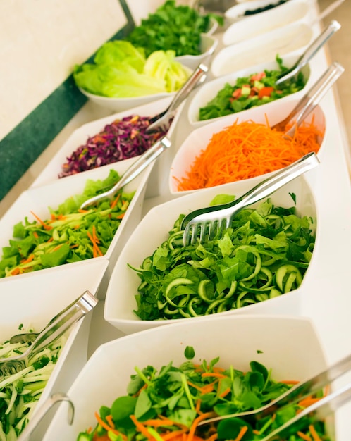 Closeup soft focus salad bar with a variety of fresh vegetables