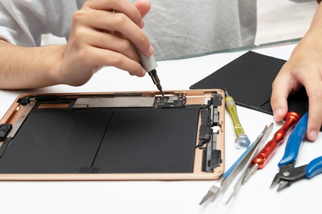 Closeup specialist process of tablet device repair