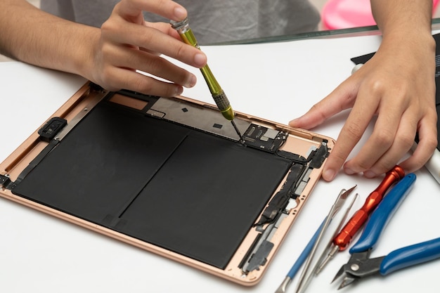 Photo closeup specialist process of tablet device repair