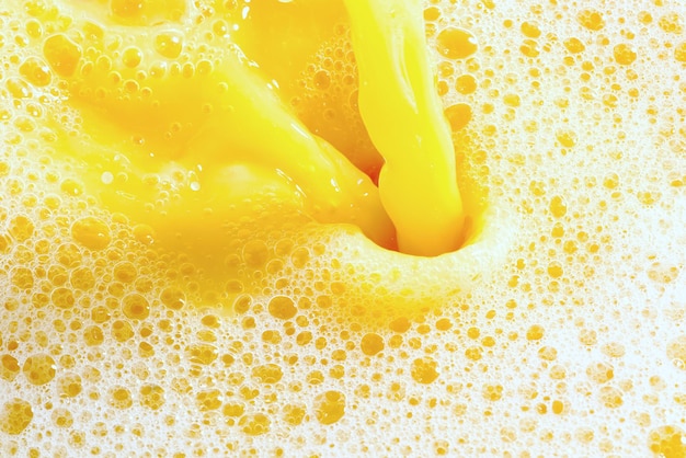 Closeup of splashing orange juice top view Splash of fresh sweet orange mango fruit juice