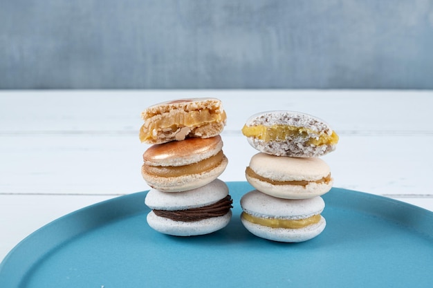 Closeup of a stack of macarons filled with chocolate ganache dulce de leche and passion fruit cream