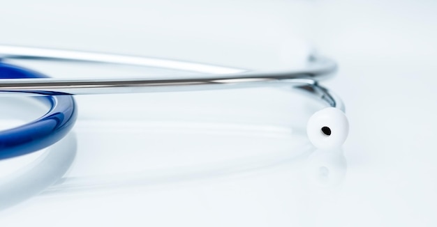 Photo closeup of a stethoscope on a light blue table