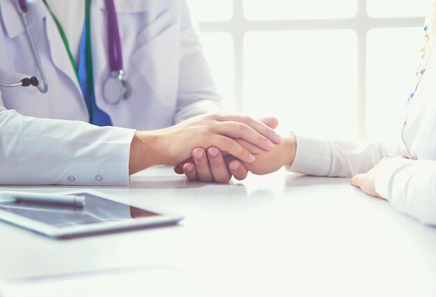 Closeup of stethoscope and paper on background of doctor and patient hands