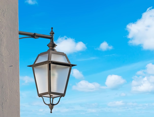 Closeup of a street lamp under a blue sky
