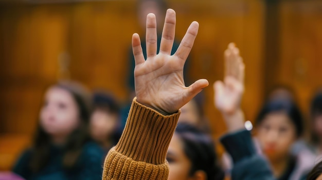 Closeup of a students hand raising in class to ask a question