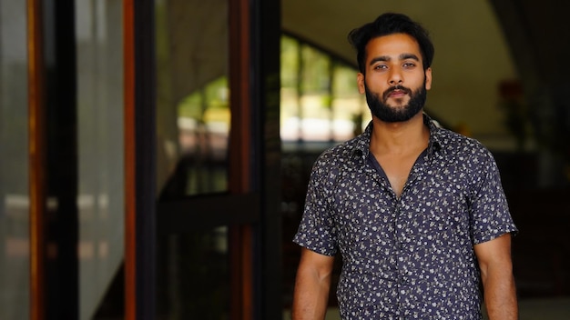 A closeup of a stylish young Indian guy with a beard in India