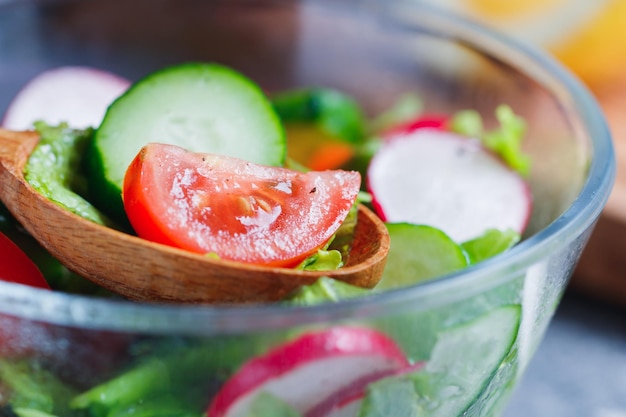 Closeup of summer fresh vegetable salad in kitchen The concept of the vegetarian and healthy food