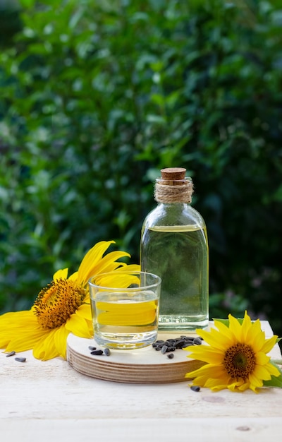 Closeup of sunflower oil in a bottle glass with seeds and sunflower